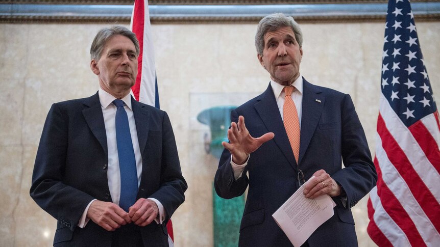 John Kerry and British Foreign Secretary Philip Hammond address the media.