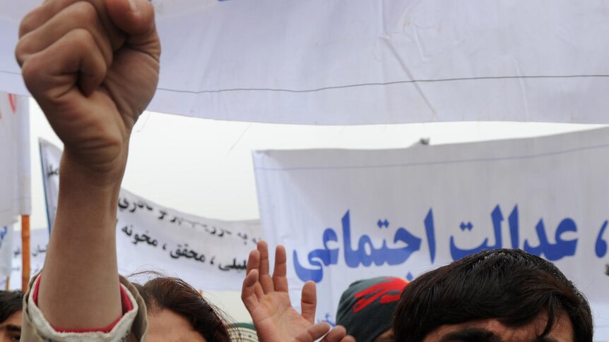 An Afghan protester shouts slogans during a demonstration