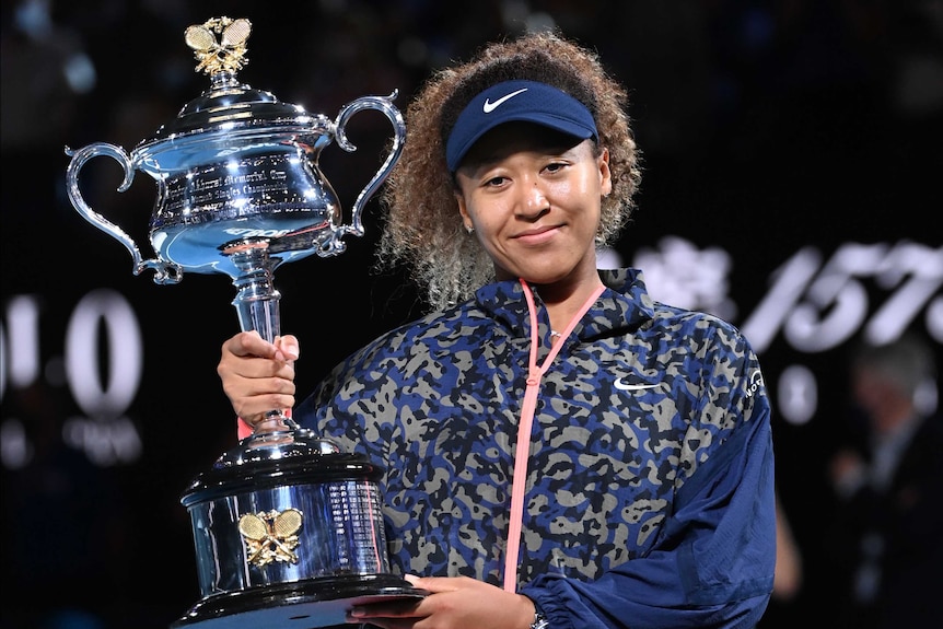 Naomi Osaka of Japan holds the trophy.