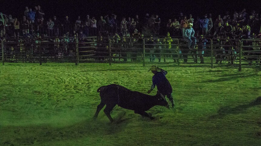 Bull fighter runs away from bull