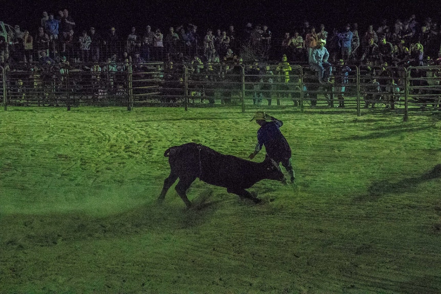 Bull fighter runs away from bull