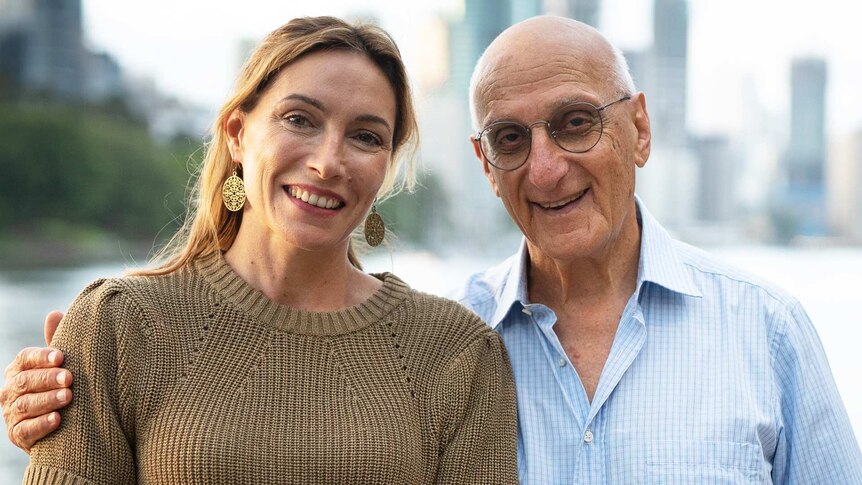 Claudia Karvan and David Malouf standing together with a city and water behind them.
