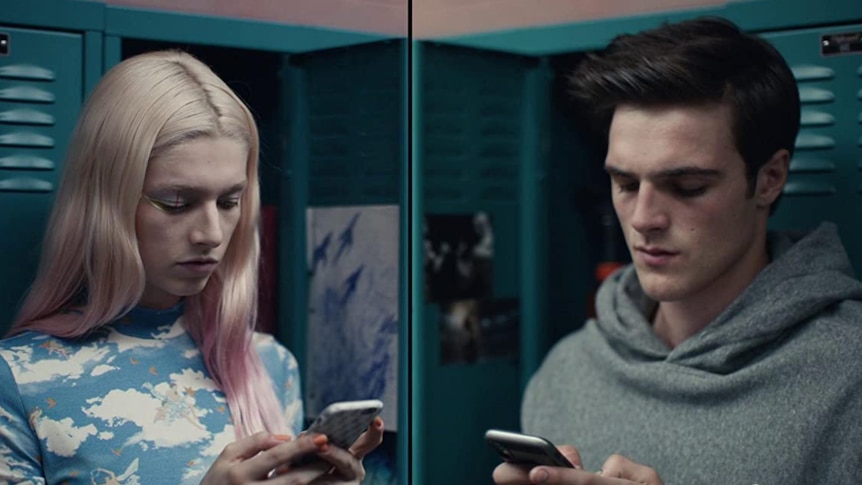 A photo of Jules and Nate from the show Euphoria, holding their phones leaning against a school locker