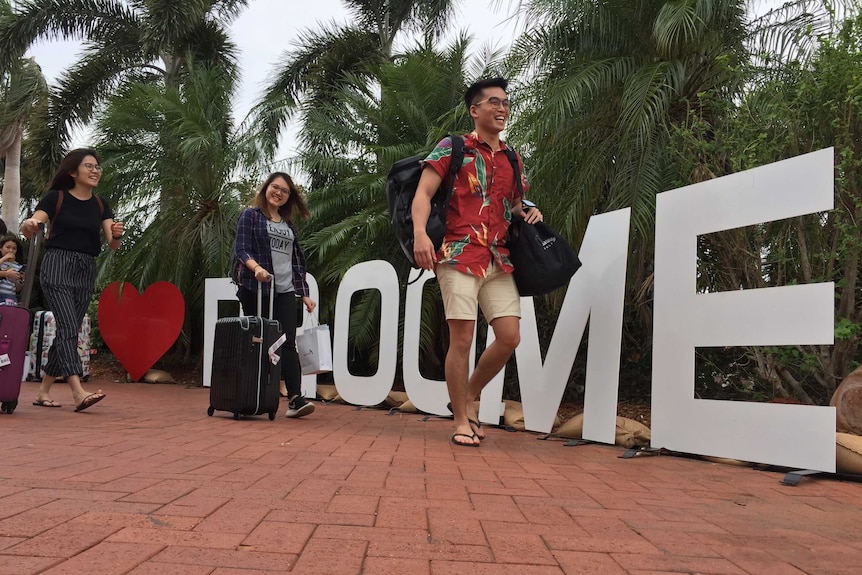 Passengers from the first Perth-Singapore flight mingle at Broome Airport.