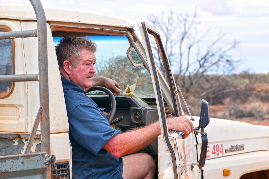 A man looks out of his ute door
