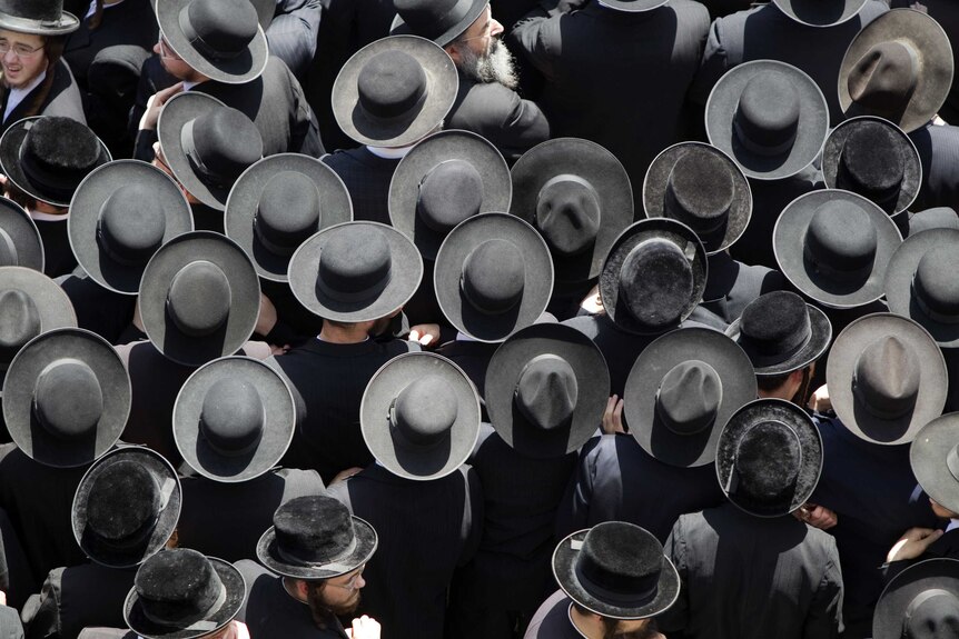 Hasidic ultra orthodox Jewish men with hats photographed from above