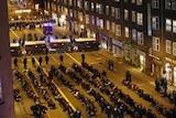 Demonstrators sit on the ground after police rounded them up during a rally