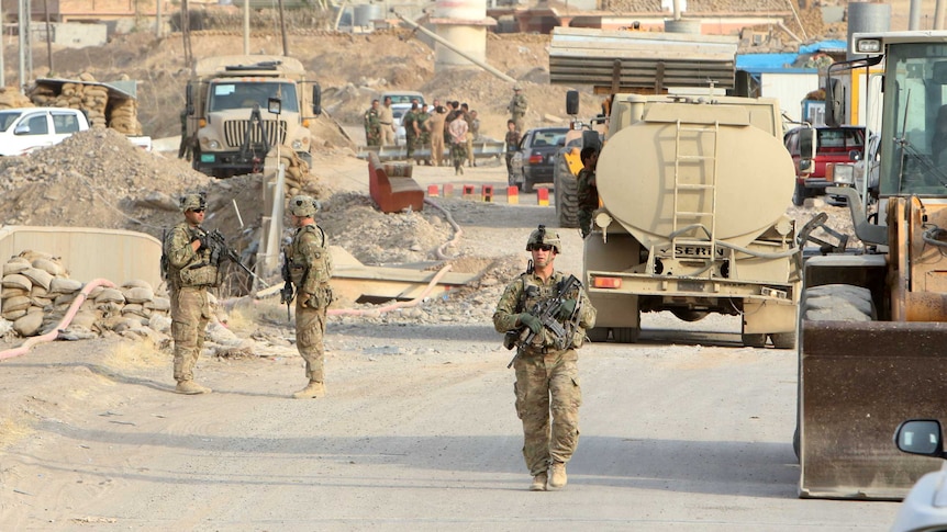 U.S. soldiers gather in the town of Gwer