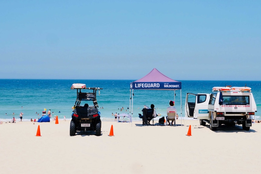 About 30 or so people go for a dip at Broadbeach