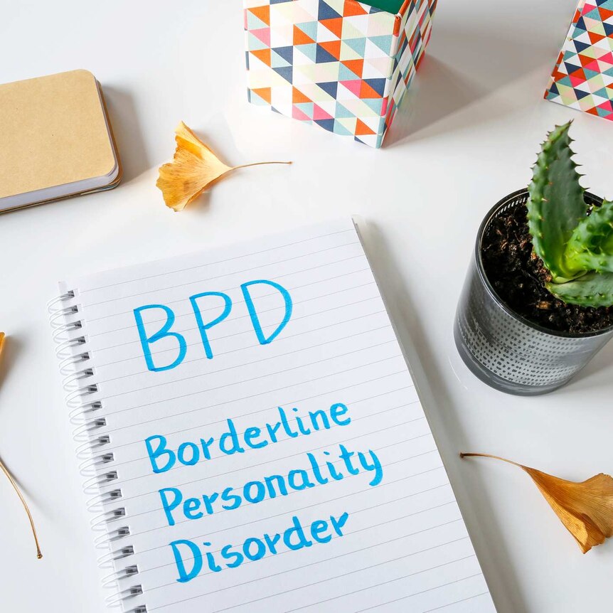 The words Borderline Personality Disorder written in notebook on white table