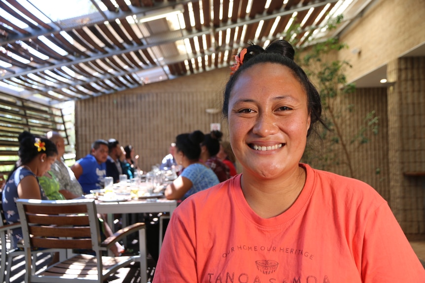 smiling Samoan woman wearing pink shirt 