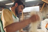 A baker at work inside Farouk Sweets