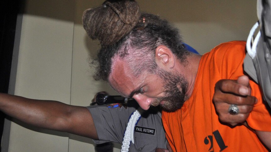 Police take British man David Taylor being taken from his holding cell in Bali