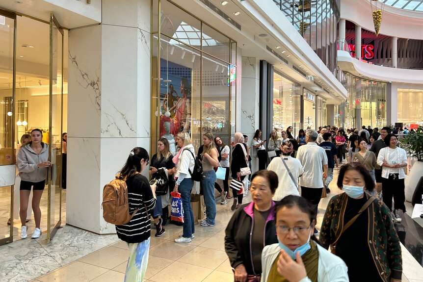 Une foule de clients traversant un magasin.