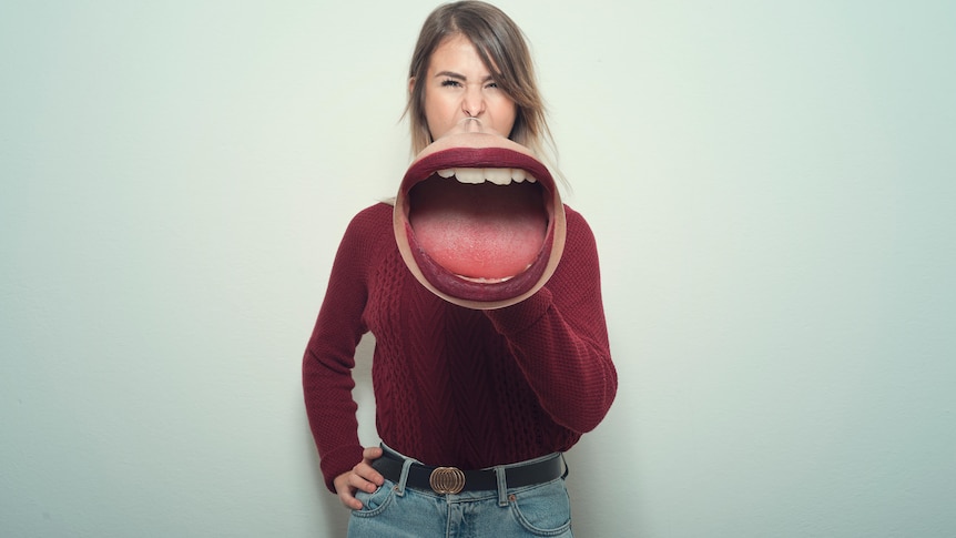 Woman talking through huge mouth that looks like a megaphone