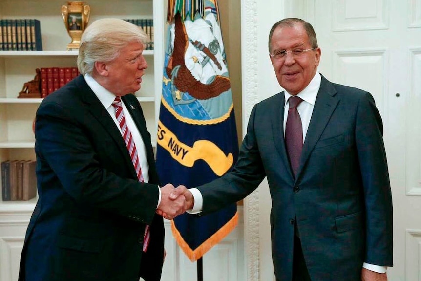 US President Donald Trump shakes hands with Russian Foreign Minister Sergei Lavrov.