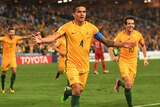 Australia's Tim Cahill spreads his arms as he celebrates after scoring.