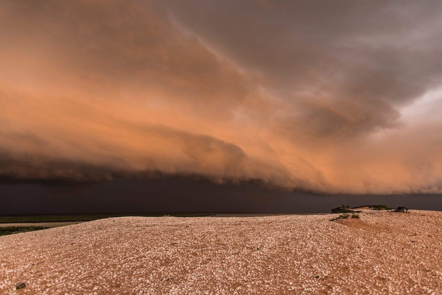 A storm cloud forms over the sand at Roebuck Bay.