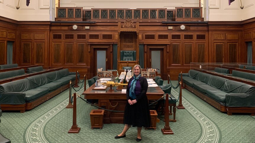A woman sits in the House of Representatives at Old Parliament House