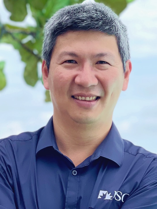 Smiling man in dark blue shirt