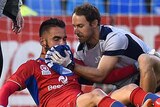 Newcastle Jets physio attends to Mark Birighitti
