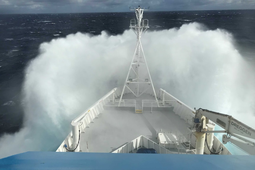 Rough seas seen splashing over the bow of a research ship.