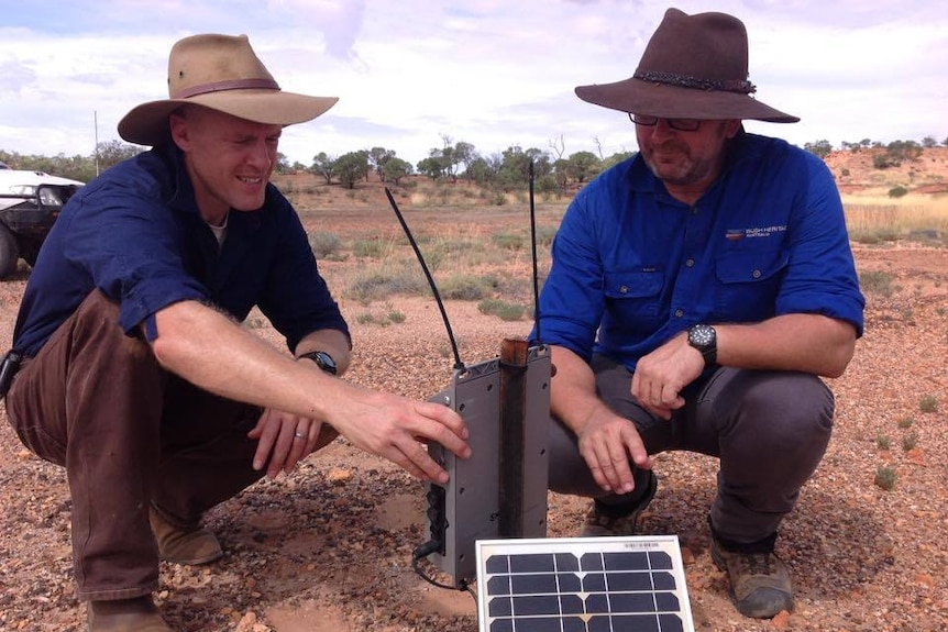UQ researcher Nick Leseberg and Bush Heritage Australia's Alex Kutt install a sound meter used to detect the night parrot.