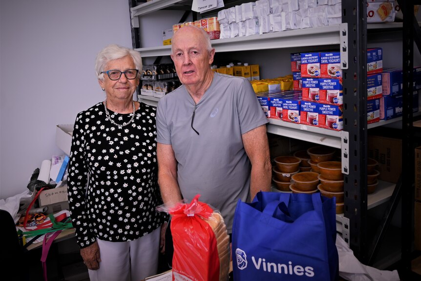 Two elderly people in a food pantry
