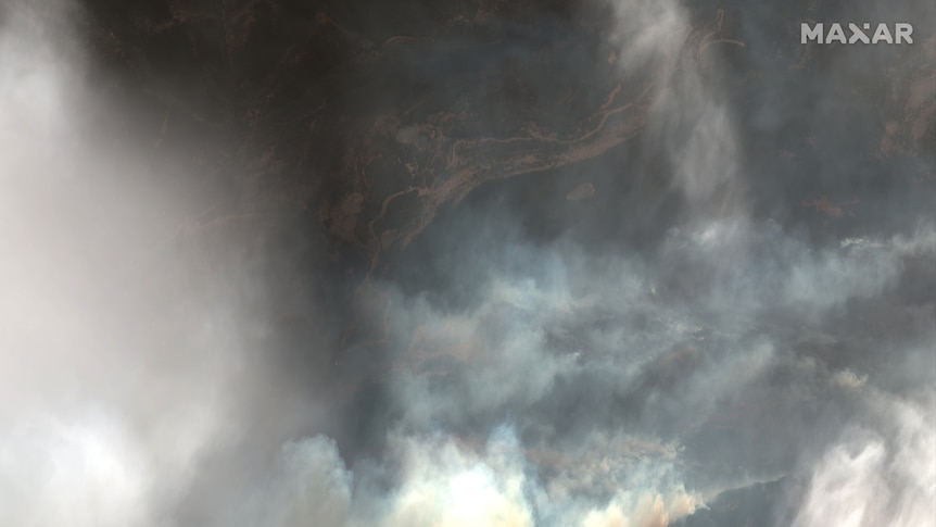 A satellite image shows smoke rising from a fire in a national park