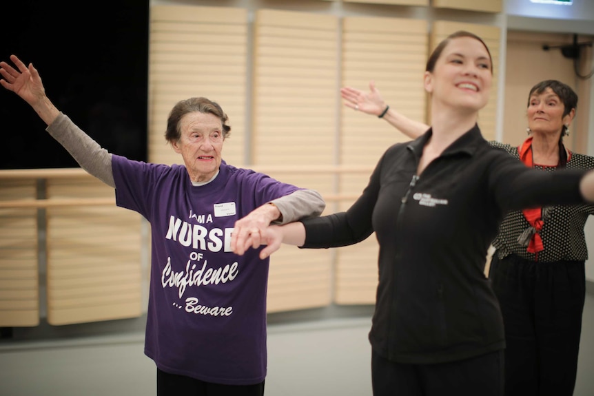 Class participant and teacher dance together.