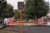 A speed sign, on country street, with a flash of light.