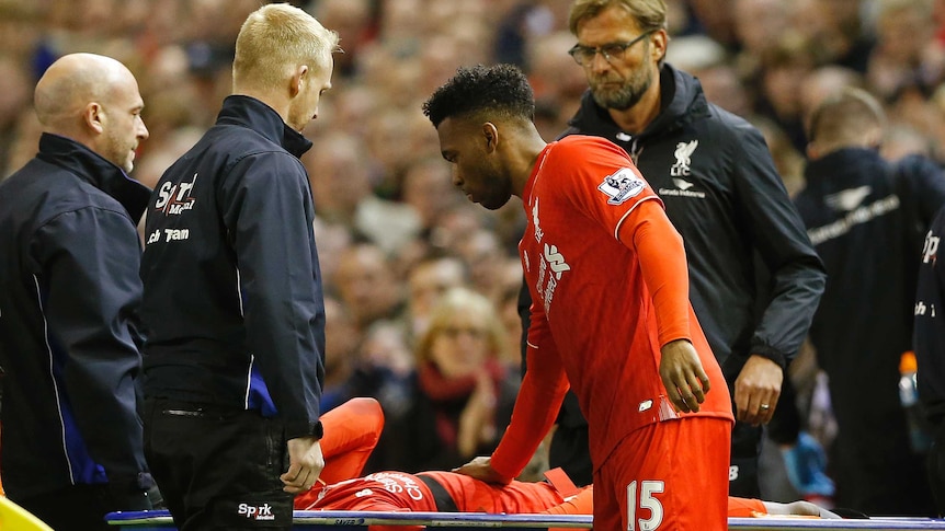Liverpool's Divock Origi is stretchered off at Anfield as Daniel Sturridge comes on against Everton.