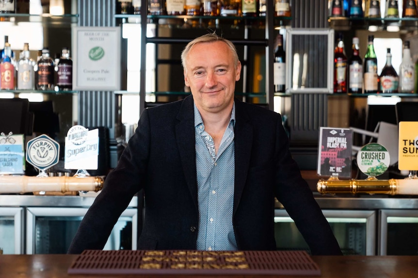 Karl Bullers standing behind the bar.