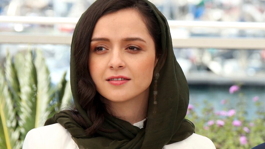 Taraneh Alidoosti looks ahead wearing a brown headscarf.