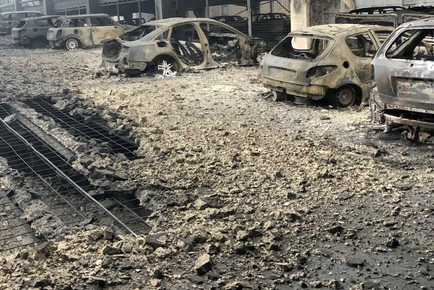 Burnt out cars inside a severely fire damaged car park