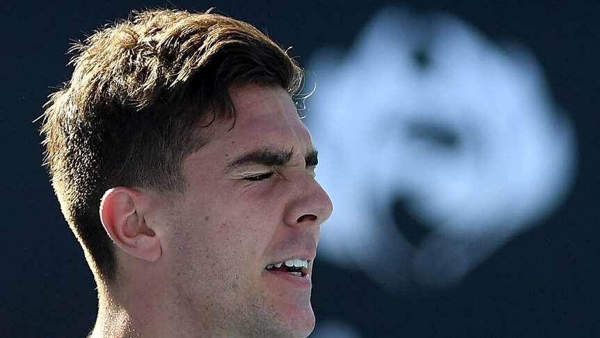 Thanasi Kokkinakis closes his eyes in frustration during his Australian Open first-round match against Daniil Medvedev.
