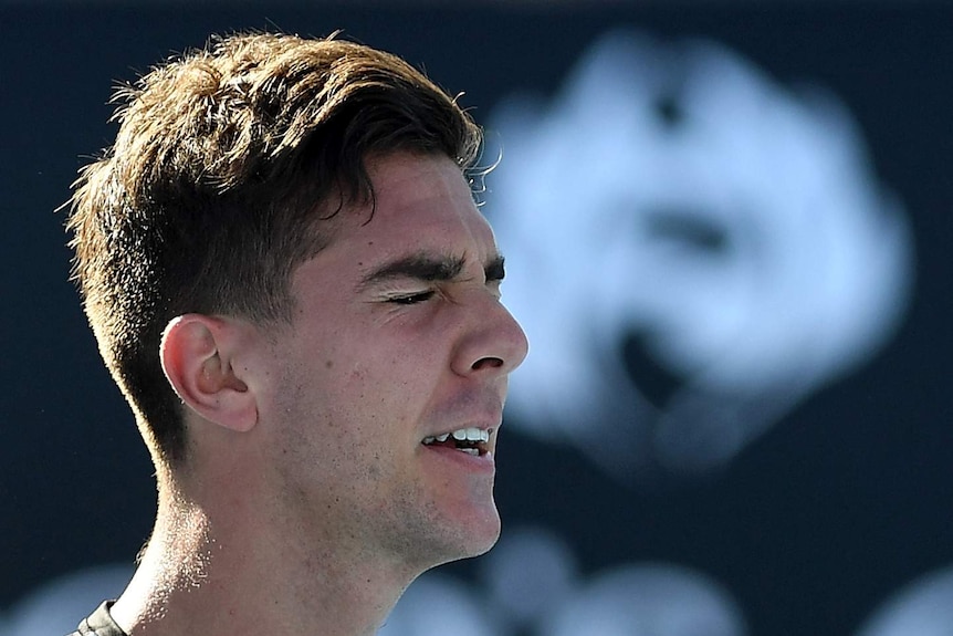 Thanasi Kokkinakis closes his eyes in frustration during his Australian Open first-round match against Daniil Medvedev.