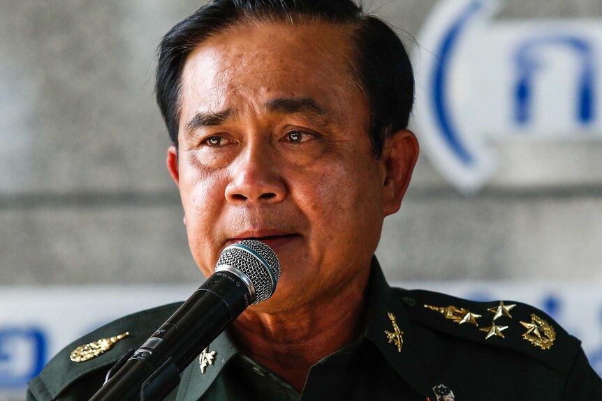 Prayuth Chan-ocha, wearing a military uniform, gives a salute