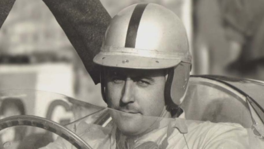 Australian motoring legend Sir Jack Brabham at the wheel of his car in the 1960s.