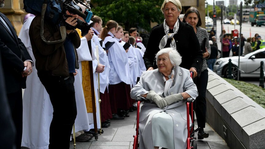 Lady Stephen, in a wheelchair, smiles as a she greets supporters.