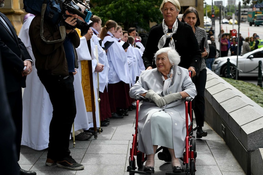Lady Stephen, in a wheelchair, smiles as a she greets supporters.