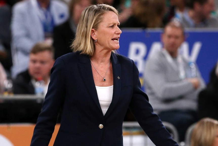 A Super Netball coach watches on courtside during a match between the Melbourne Vixens and Adelaide Thunderbirds.