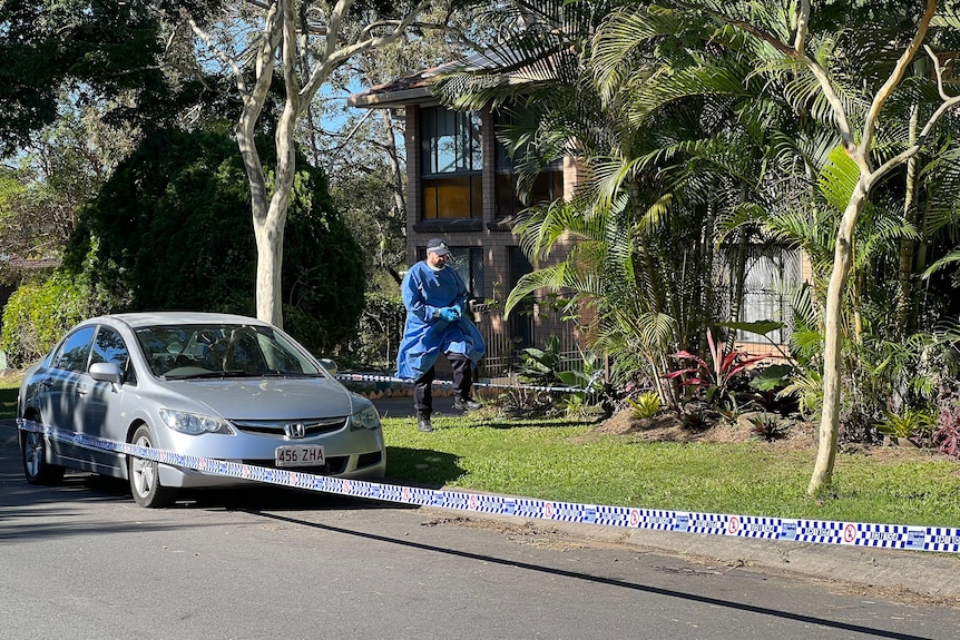 Police tape and a forensic officer outside Huni's home.