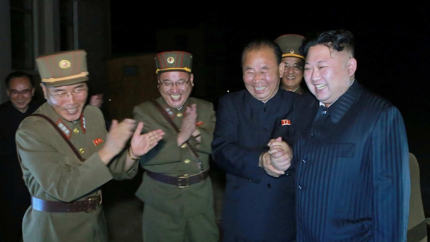 Kim Jong-un celebrates with North Korean ofiicials