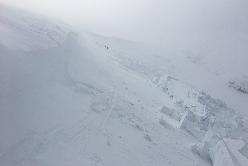 A section of snow on the side of a mountain has collapsed.