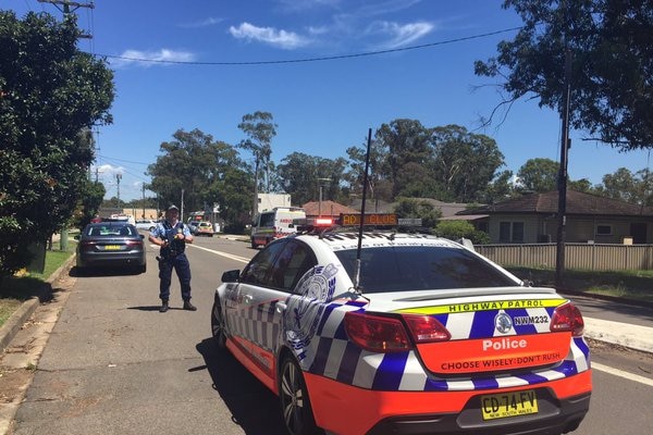 Policeman and car on road at Quakers Hill