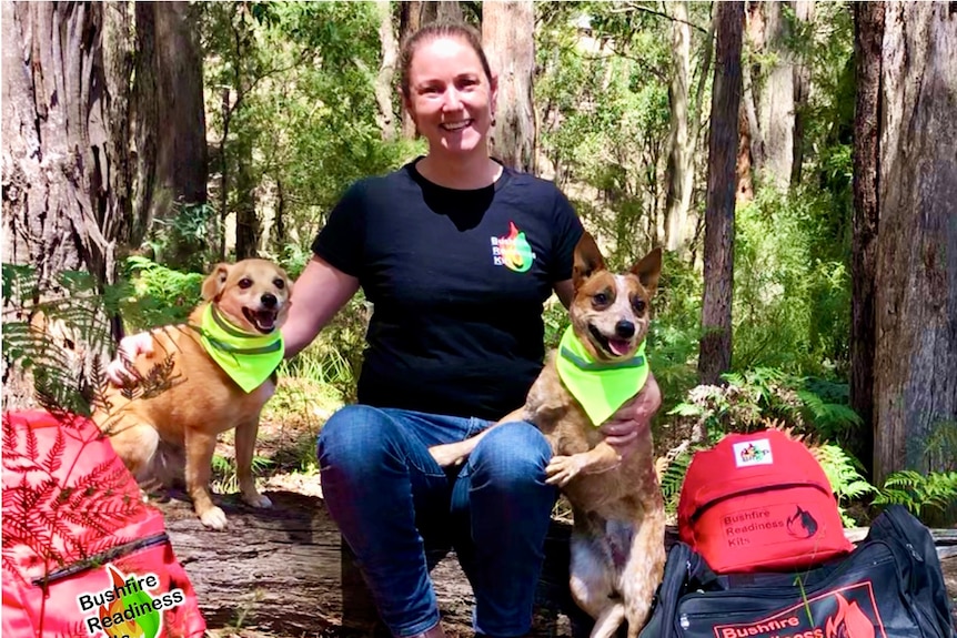 A woman poses with her two dogs