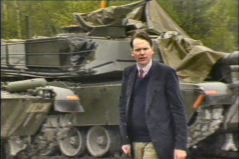 Mark Colvin in Germany in front of a tank