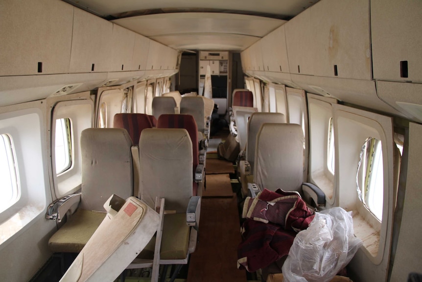 Dishevelled and falling apart inside of an old plane.