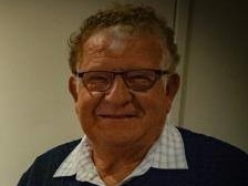 A grainy photo of an old man wearing glasses